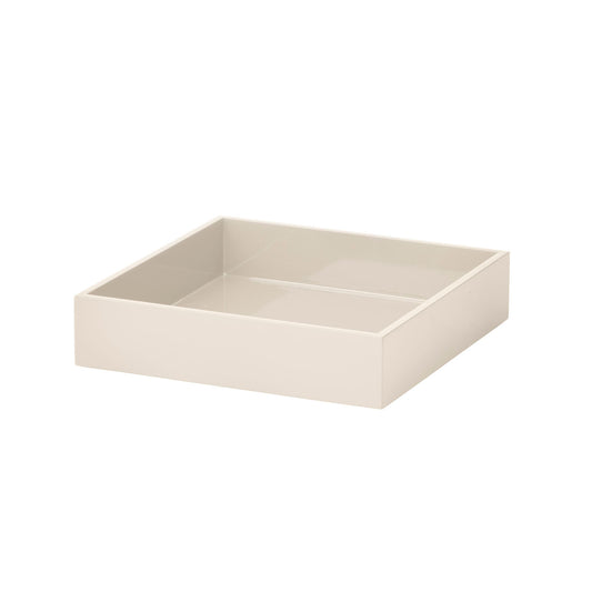 A minimalist, square, open-top storage tray or drawer organizer in a warm cream or off-white color, shown from a three-quarters perspective on a solid white background.