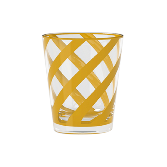 Clear glass tumbler with yellow woven pattern on a white background