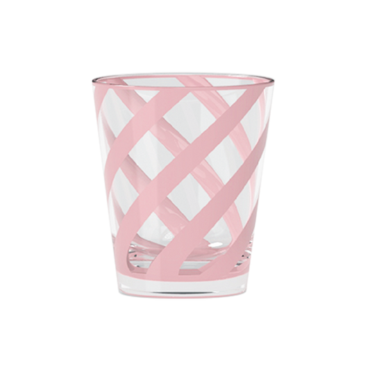 Pink and white patterned glass tumbler on a white background