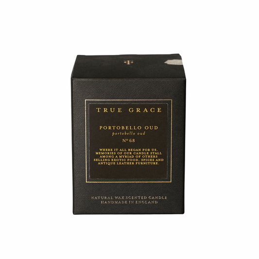 Black candle box with gold text on a white background