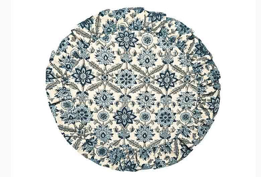Round blue and white patterned placemat on a white background